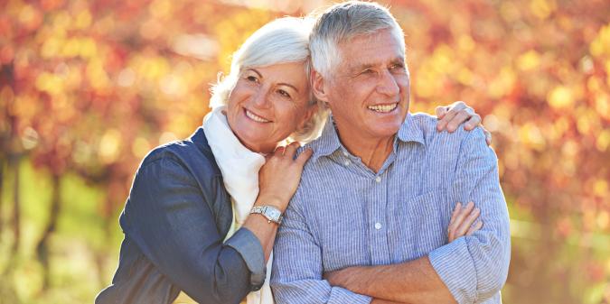Happy senior couple smiling together outdoors
