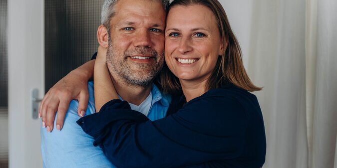 A happy couple is having fun at home