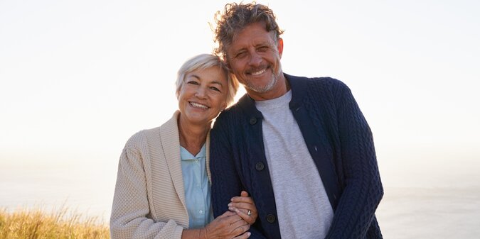 Smile hill and portrait of senior couple in nature