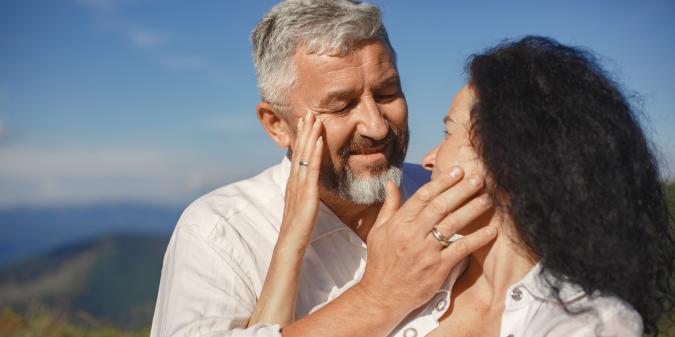 Senior couple holding hands smiling second marriage
