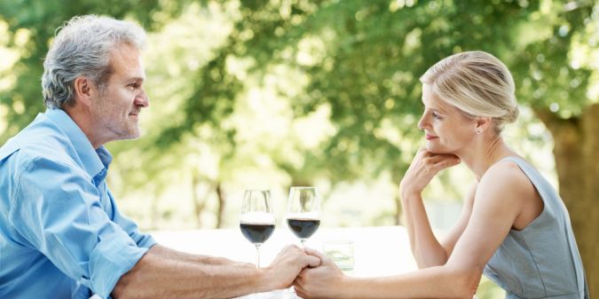 Senior couple enjoying dinner, showcasing trust and respect.