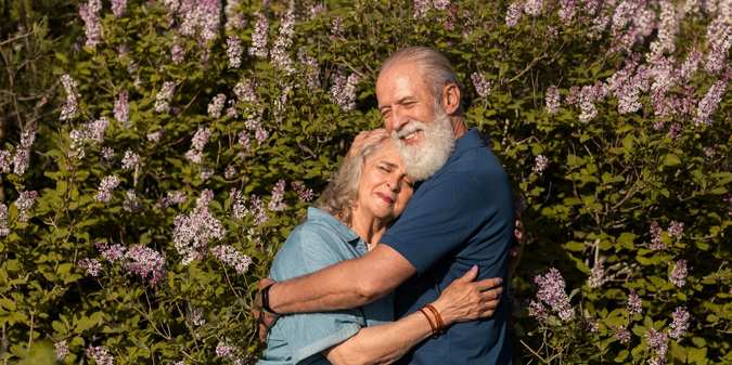 Senior couple embracing and reflecting on life goals.