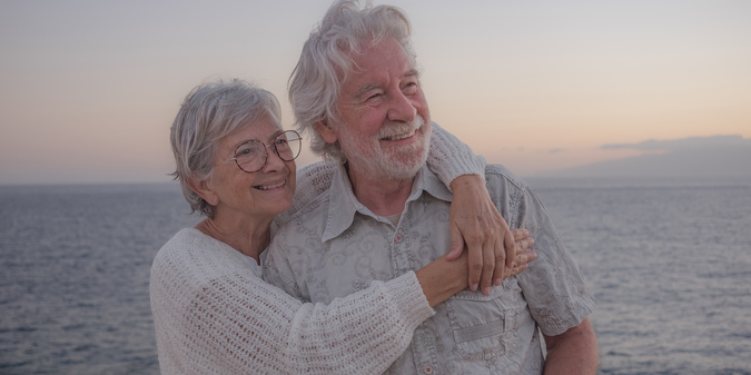 two happy romantic seniors pensioners embraced sea