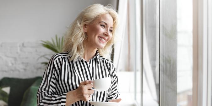 Senior woman looking hopeful smiling outdoors