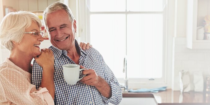 coffee kitchen and smile with senior couple