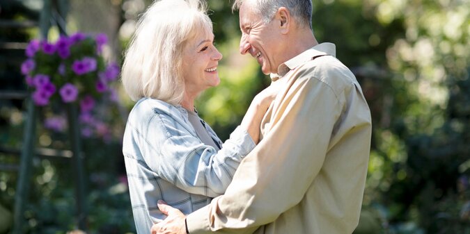 Happy senior spouses dancing in garden