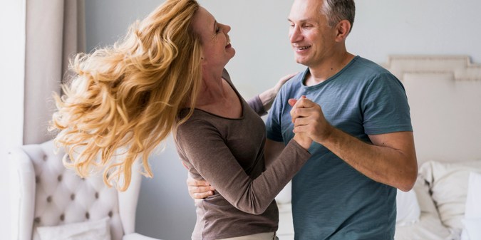 Adorable senior man and woman dancing together
