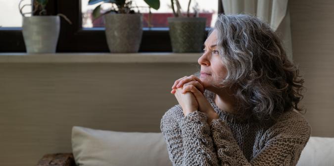 Senior woman looking thoughtful and hopeful