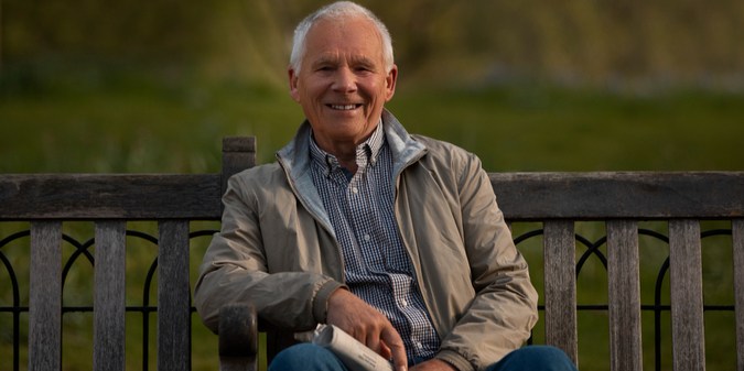 Front view old man sitting on bench